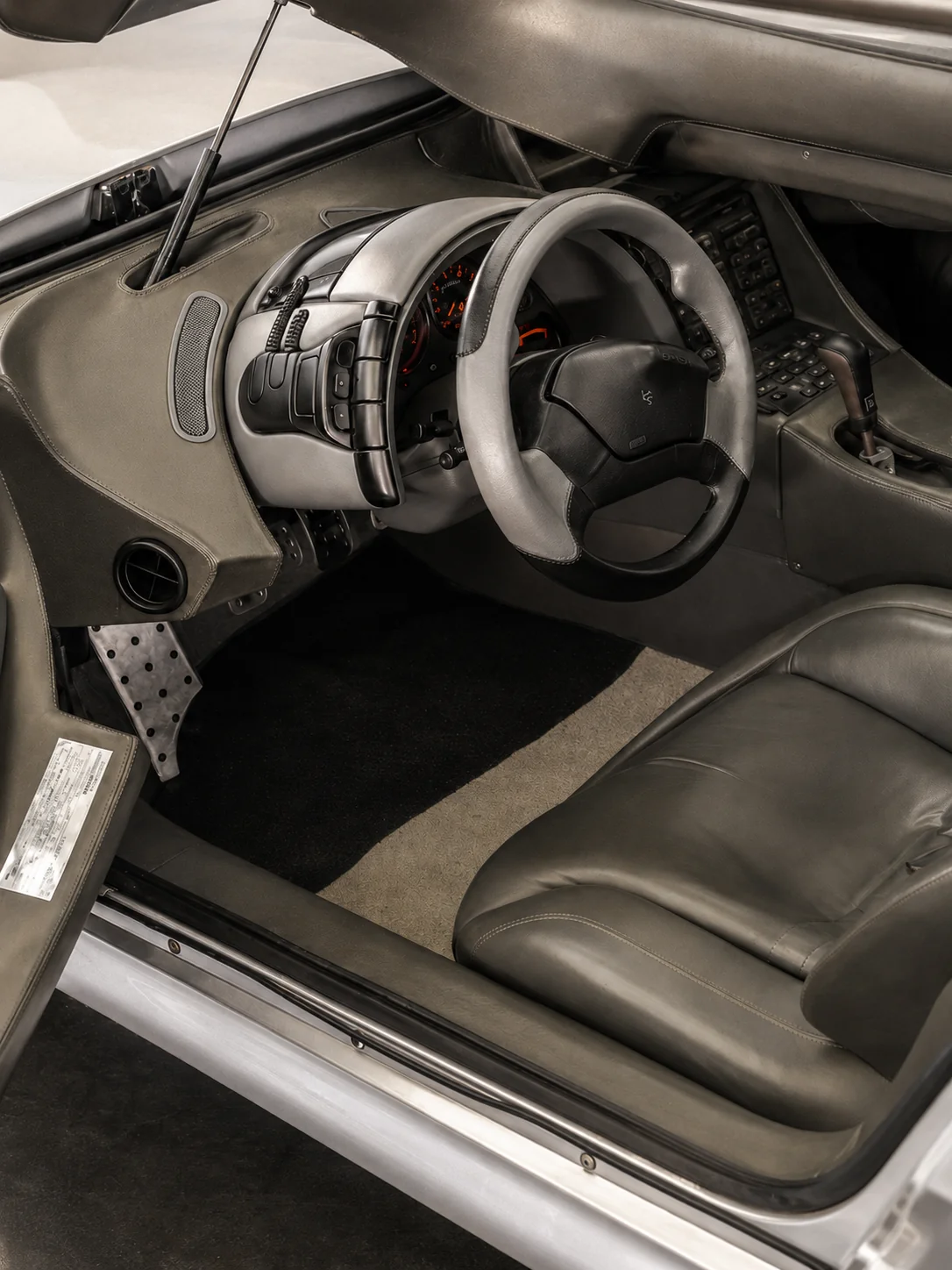 Looking down into the Aztec's driver cockpit with the canopy raised, showing the Nardi wheel, instrument bank and JVC audio stack