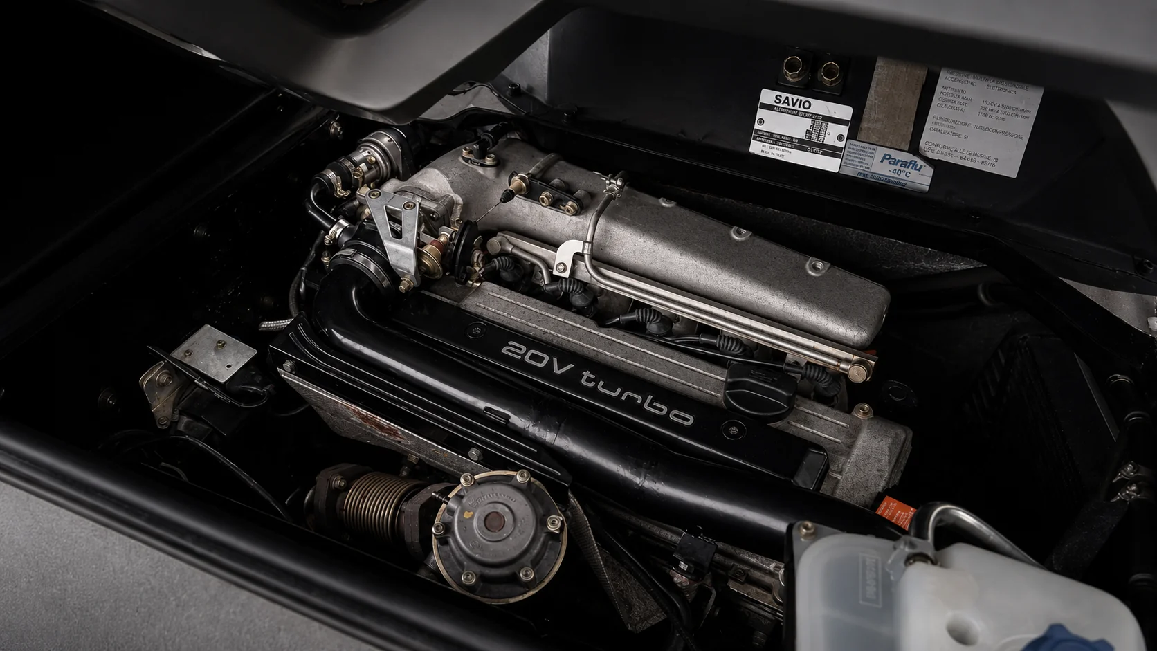 The turbocharged five cylinder engine mounted behind the cabin, with its twenty valve cam cover and Savio body plate